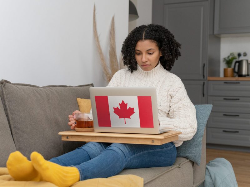 woman-working-from-home-laptop-with-canadian-flag